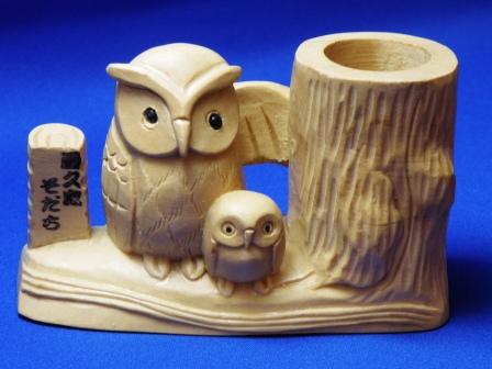 A toothpick stand of an owl carved by hands