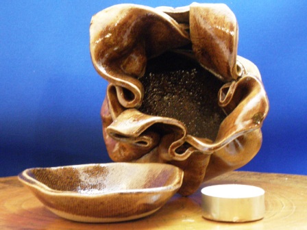 A brown incense burner for green tea leaves